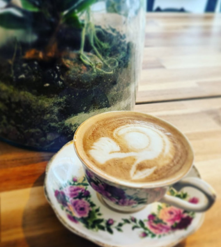 A cappuccino in a floral teacup