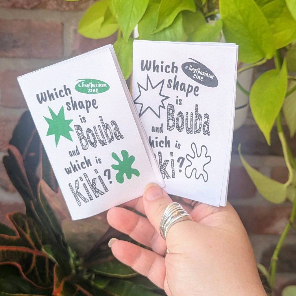 Two zines in front of some green plants. The title is "Which shape is Bouba and which is Kiki?" One zine is black and white, and one is color.
